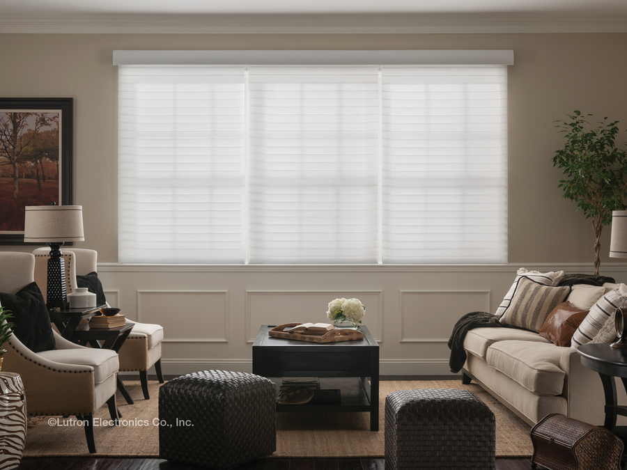 A living room with white Lutron shades lowered and covering the windows.